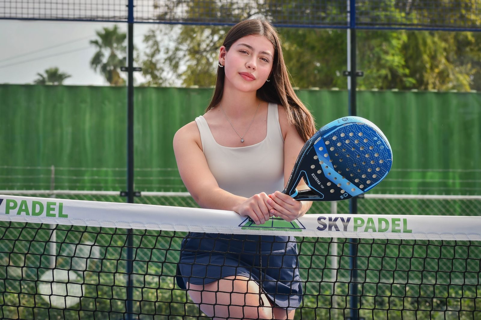 Açık hava padel kortunda elinde raketle duran bir oyuncu